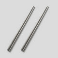Two PureTi titanium chopsticks on a light gray background