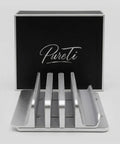 Aluminium cutting board stand with 'PureTi' branding on a black box in the background