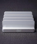 Front view of the PureTi aluminium cutting board stand with engraved PureTi logo on a dark gray background
