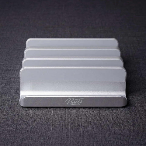 Front view of the PureTi aluminium cutting board stand with engraved PureTi logo on a dark gray background
