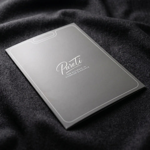 Gray sleeve with 'Pureti' branding on a dark fabric background