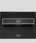 Black box with 'Pureti' branding on a matching black silicon mat against a light gray background