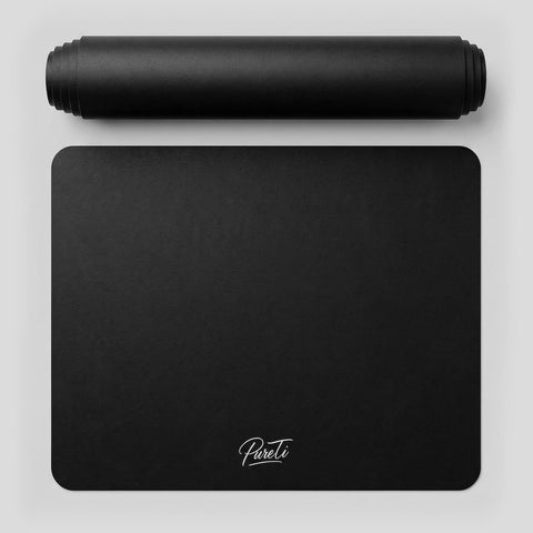 Black silicone kitchen mat with 'PureTi' branding on a light gray background