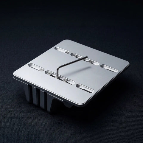 Underside of the PureTi aluminium cutting board stand showing the base plate on a black fabric background