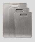 Three PureTi titanium cutting boards in small, medium and large sizes on a light gray background
