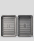 Two PureTi titanium baking trays with ridged bases, top view on a light gray background
