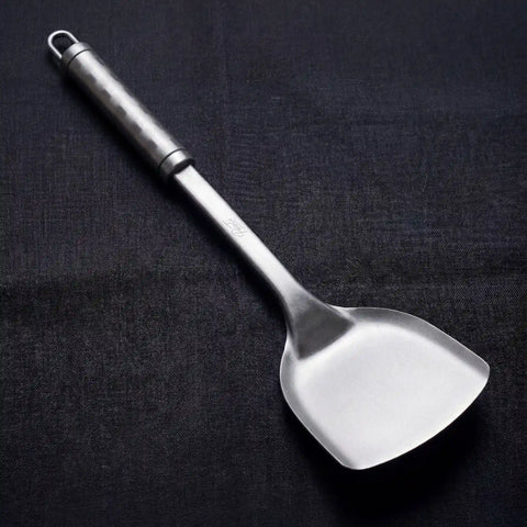 PureTi titanium solid turner on a black fabric background