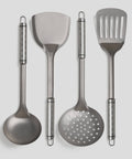 Set of four PureTi titanium kitchen utensils on a light gray background