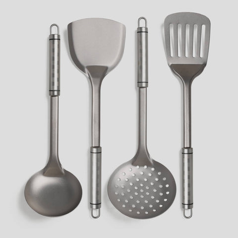 Set of four PureTi titanium kitchen utensils on a light gray background