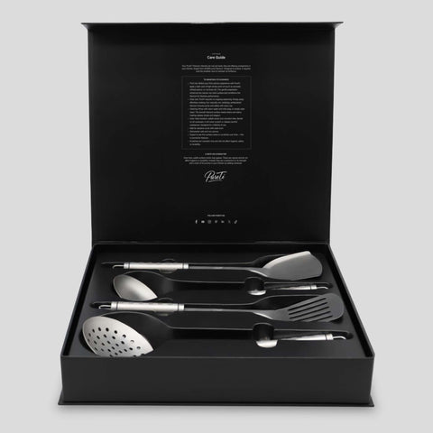Set of PureTi titanium utensils in a black box on a light gray background